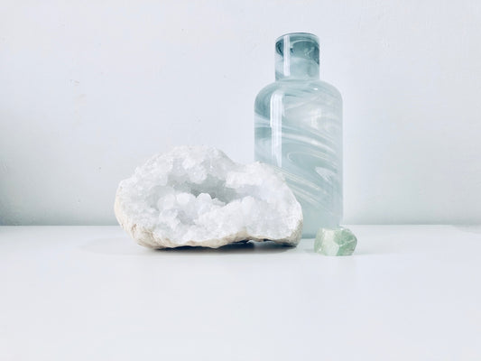 white geode beside clear bottle