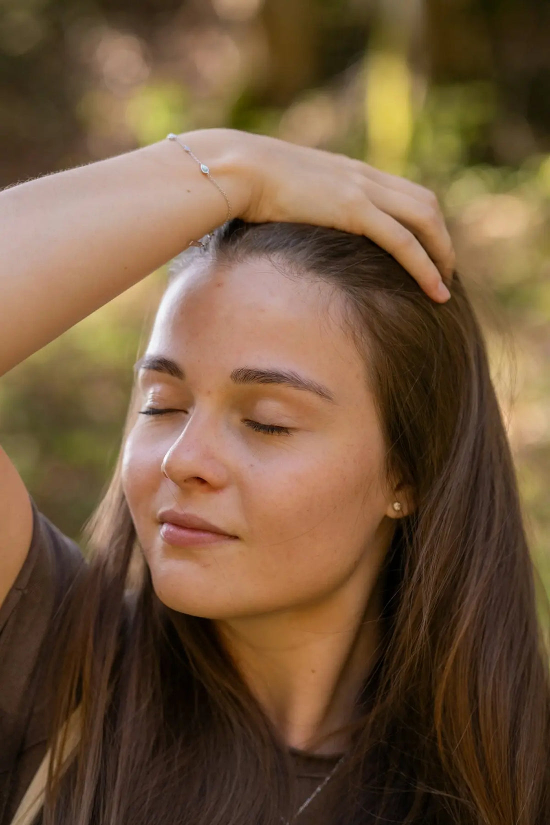 A woman is holding her hair in her hands