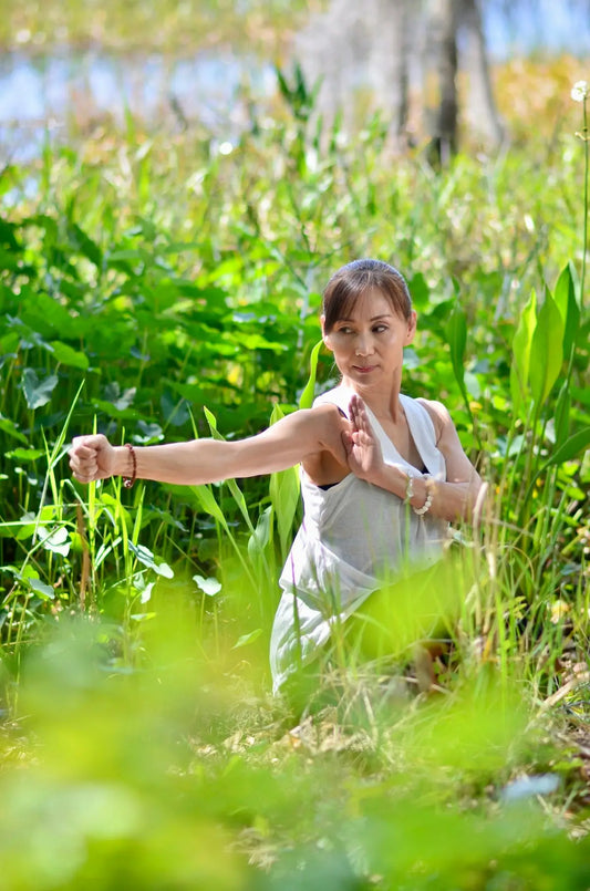 a woman standing in a field of tall grass